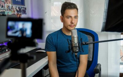 homme assis sur une chaise devant un microphone à condensateur